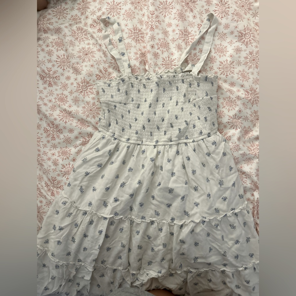 White sundress with blue flowers on it.